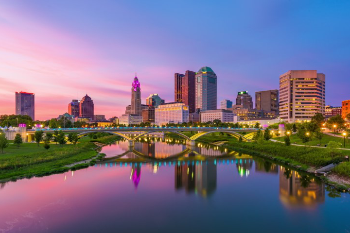 Columbus skyline at dusk reflected off river