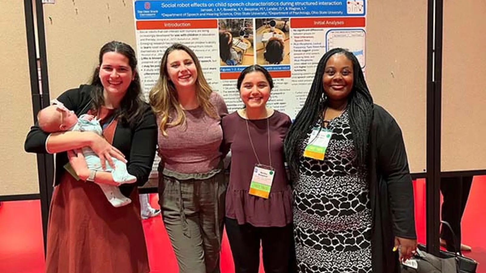 students in front of research poster