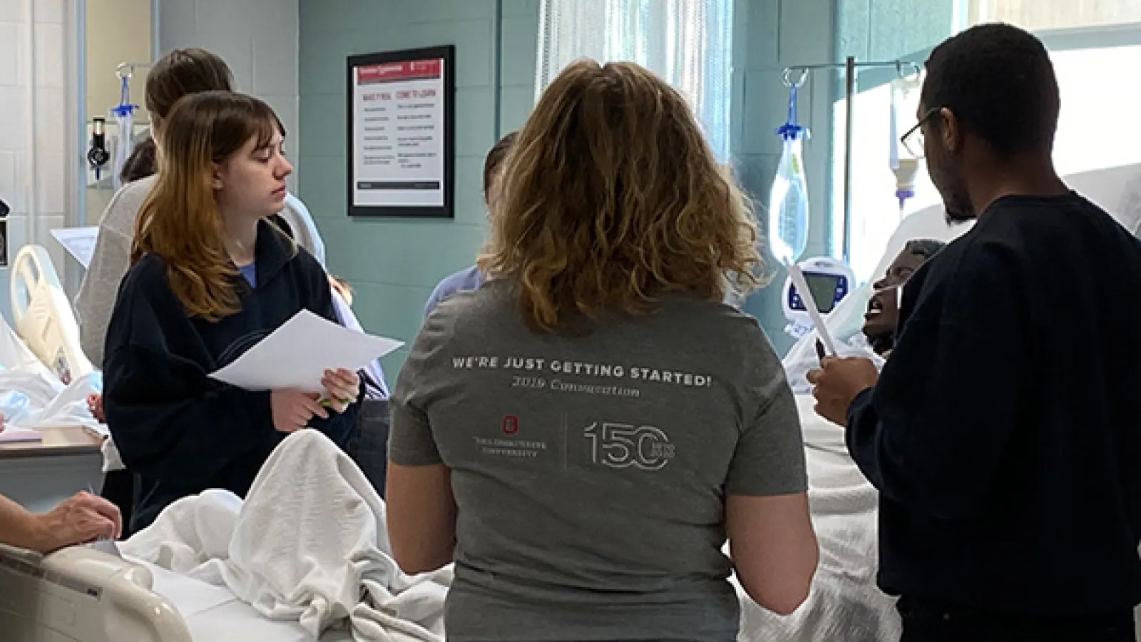 Students conducting mock assessment in medical setting