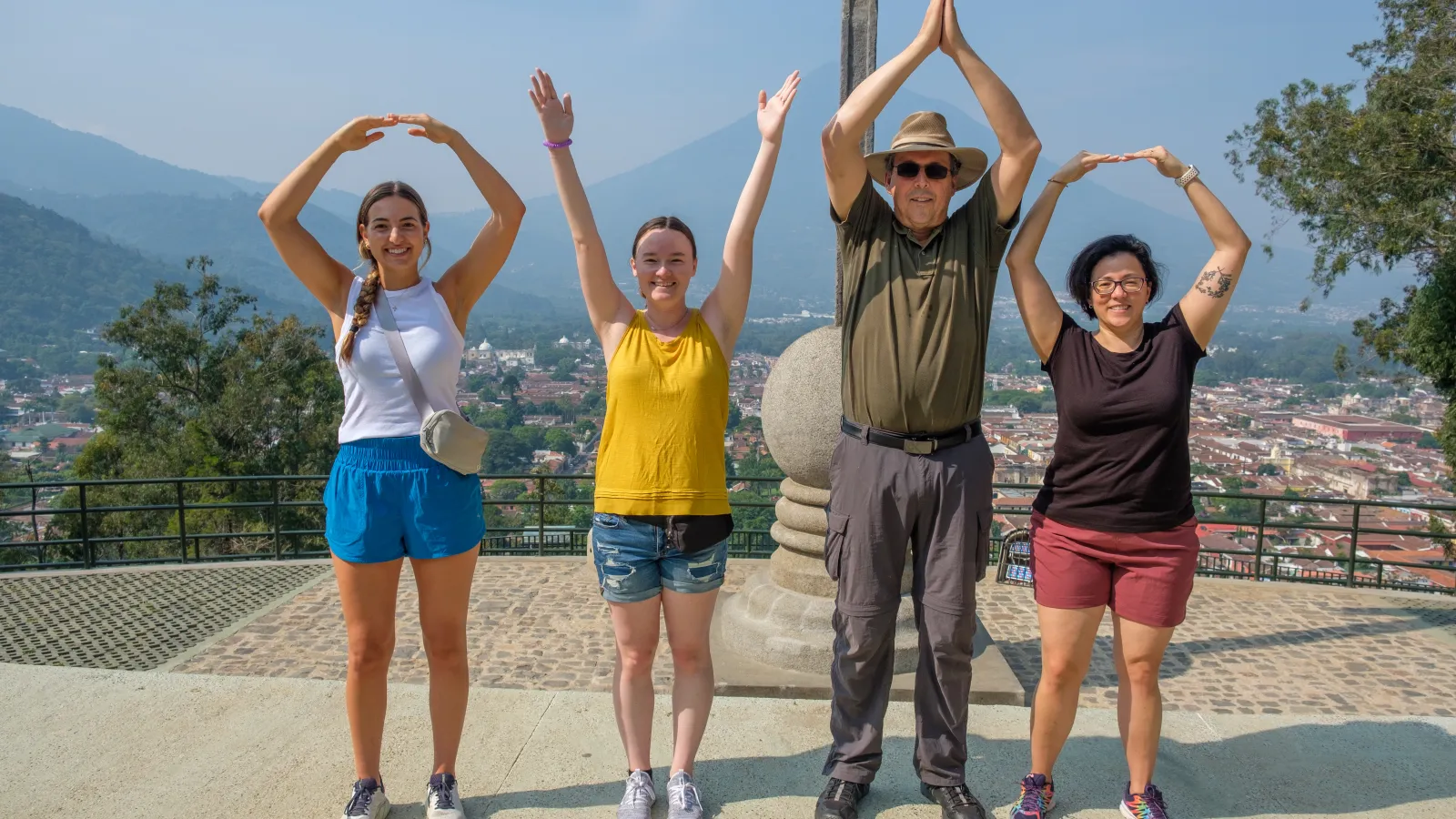 Four people in O-H-I-O formation