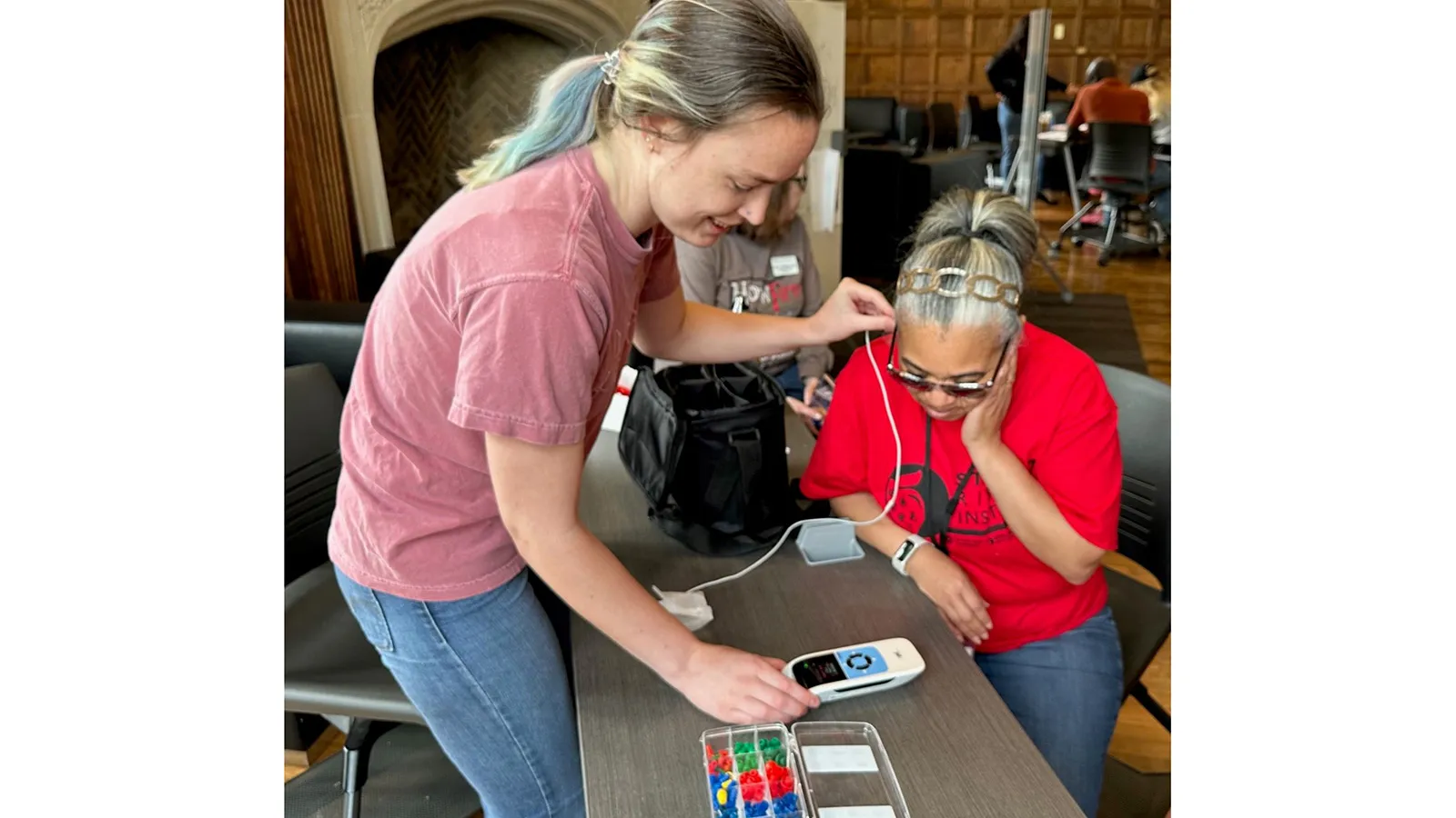 A student conducting a hearing assessment on a participant