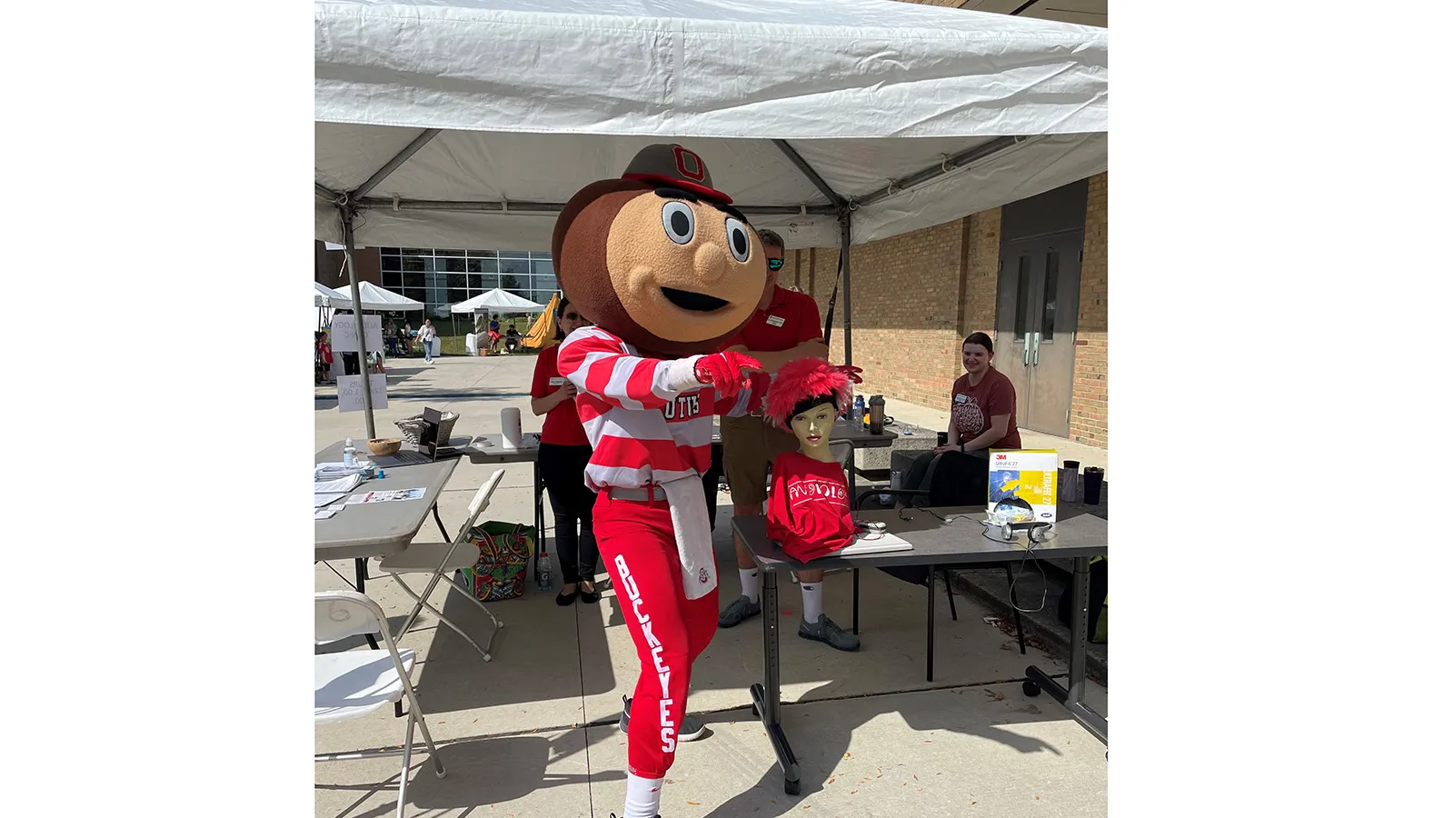 Brutus posing under tent display