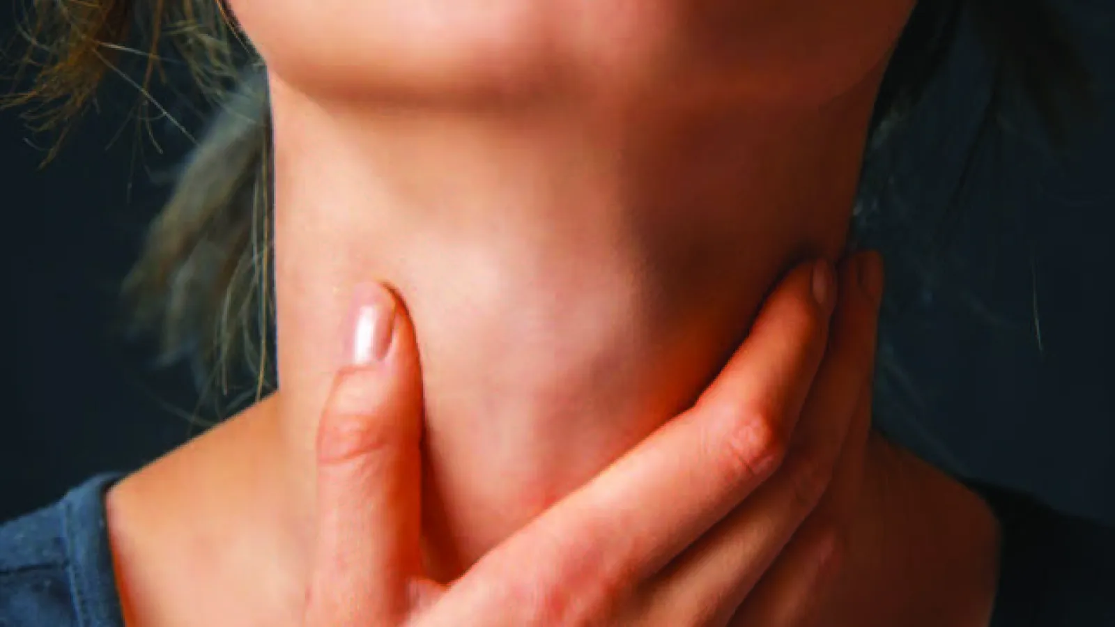 upclose image of hand touching throat