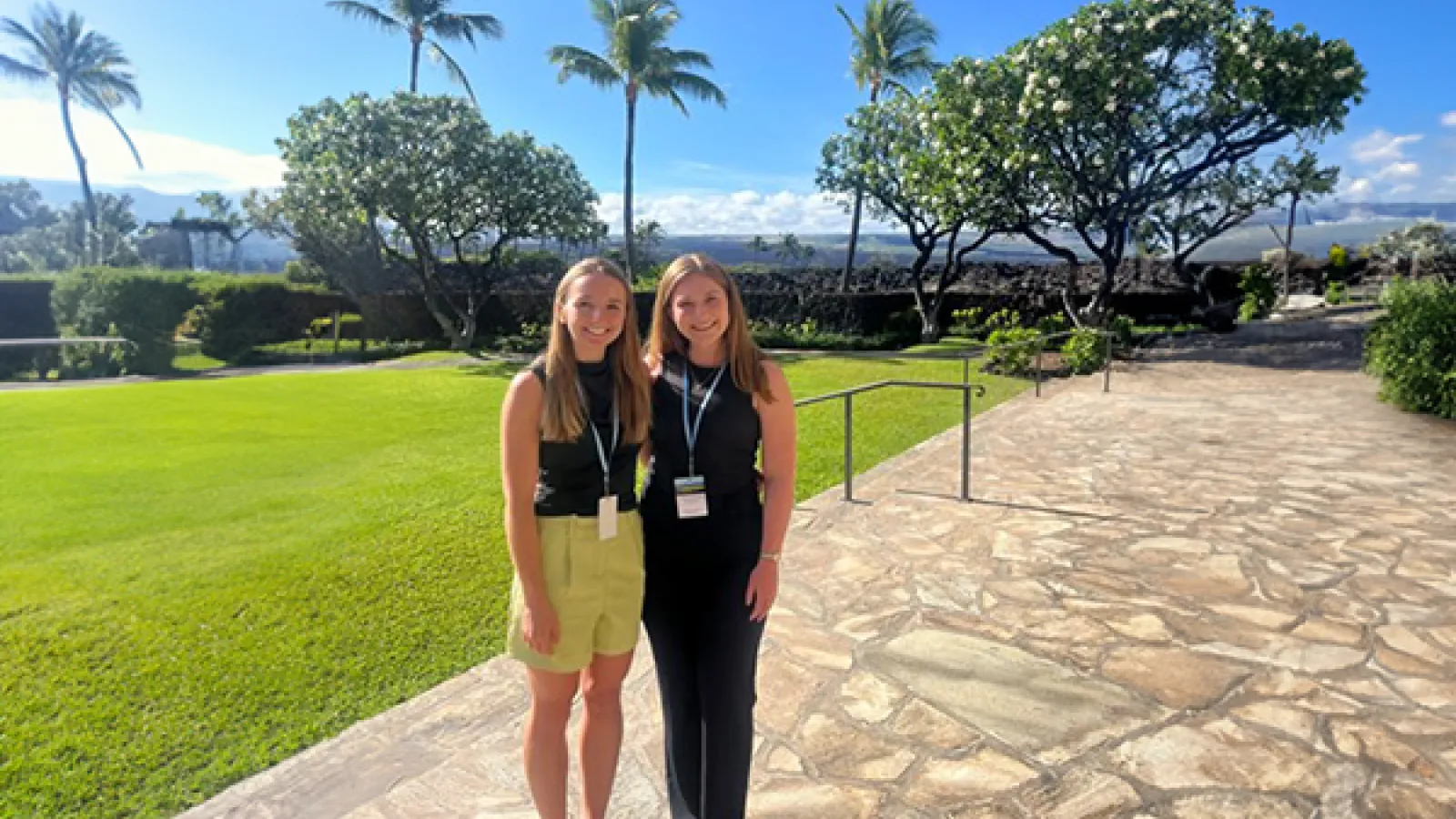 Courtney Jewell and Grace Terry standing in front of palm trees