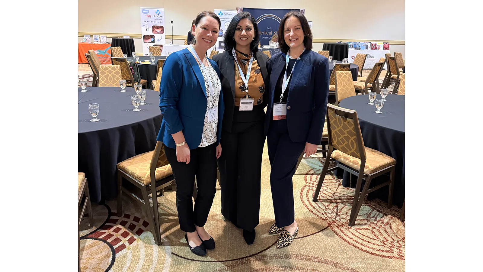 3 people posing at conference