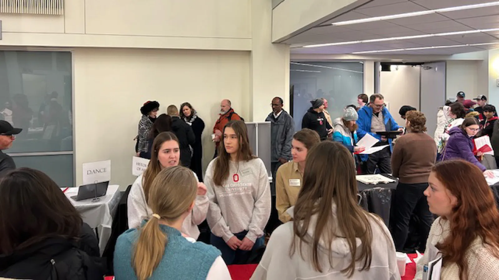 Students engaged in conversation at recruitment event