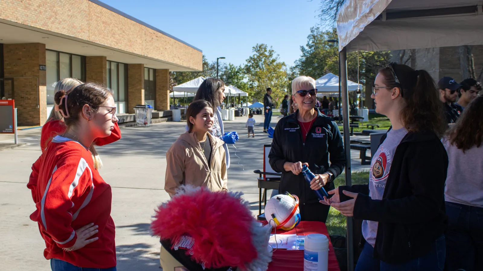 students gathering around outside of Pressey Hall at Audiology tent