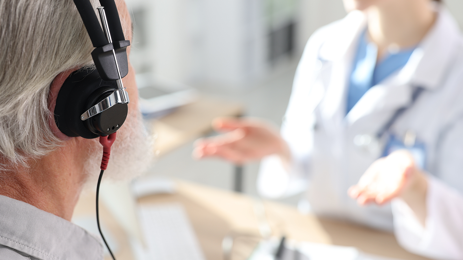 Patient with audiometric headphones undergoing hearing test in clinic