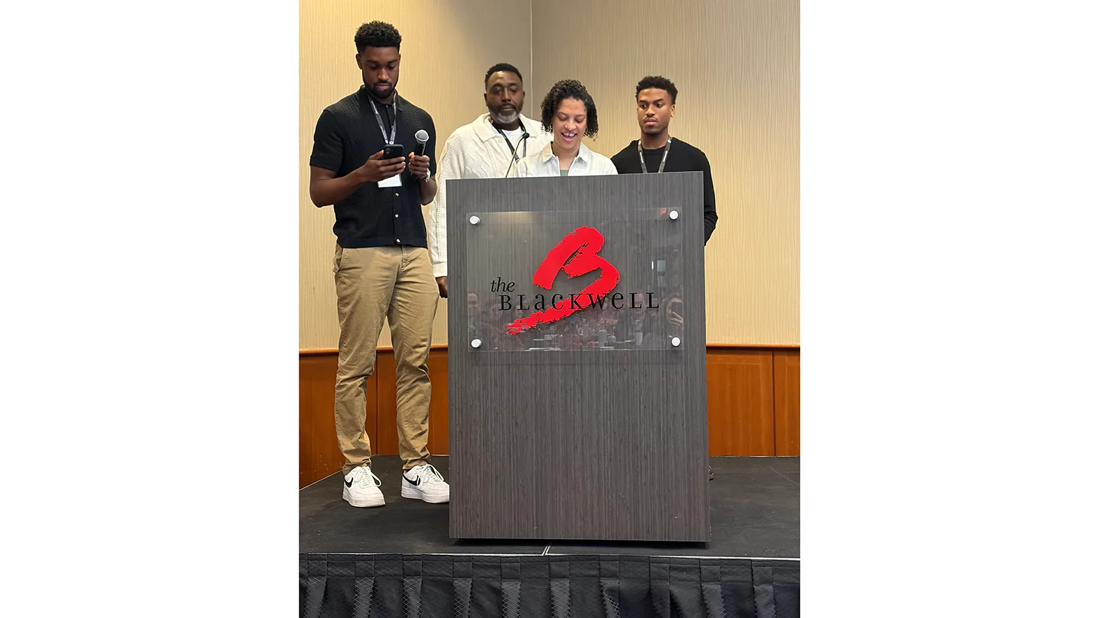 Family of four standing behind podium