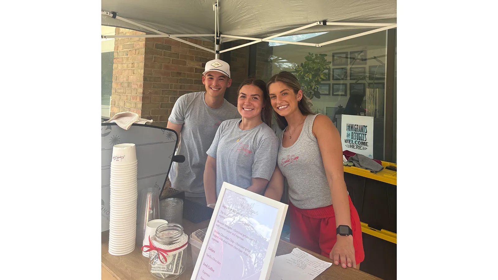 3 students at beverage cart