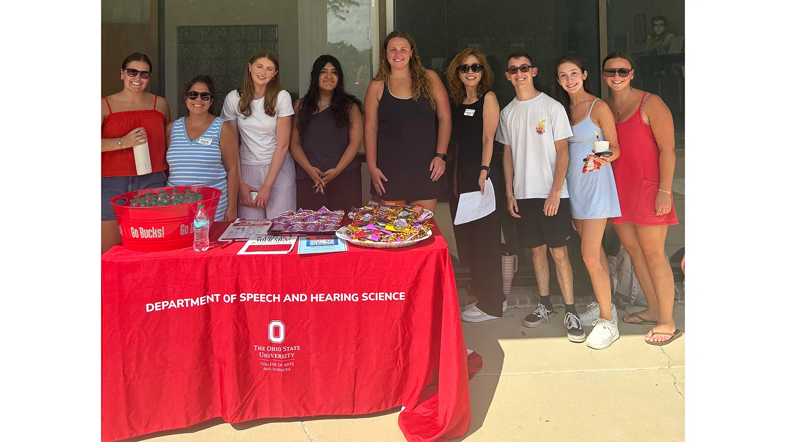 Group photo of students behind snack table