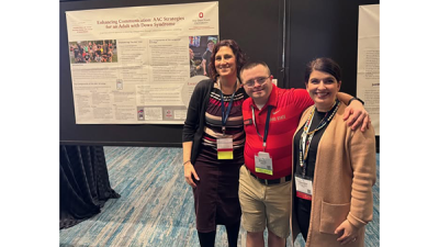 3 people posing in front of research poster