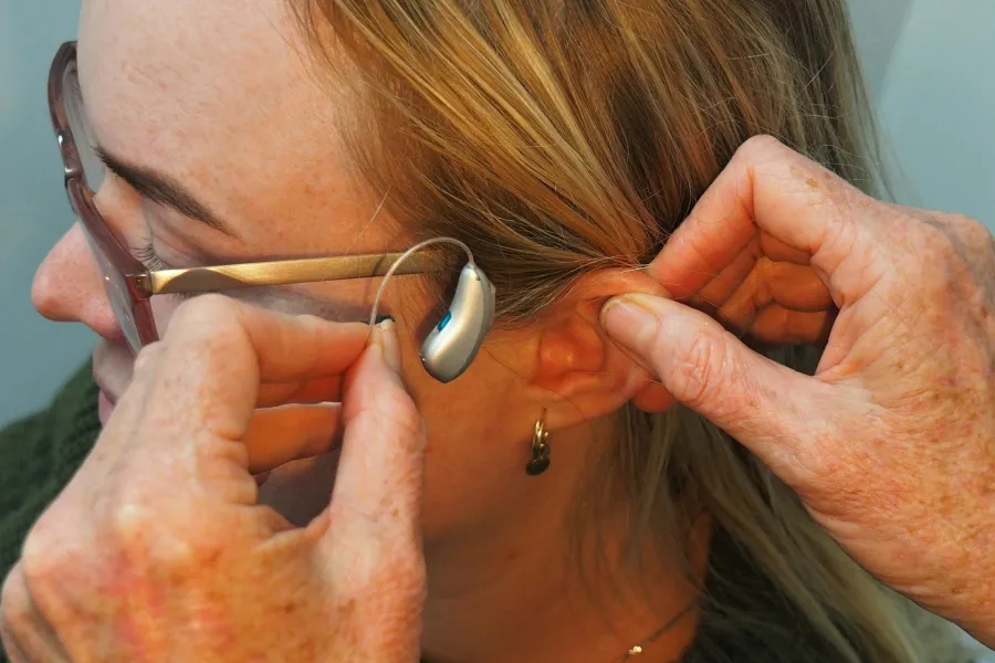 fitting of a RIC hearing aid to a woman's ear