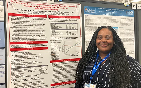 Kristina Bowdrie with research poster at conference