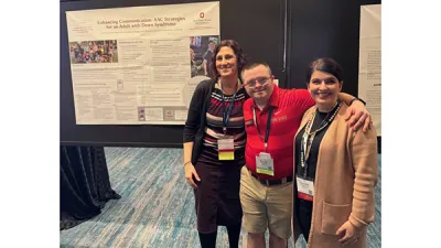 3 people posing in front of research poster