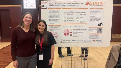 Dr. Lundine and Abby Altman standing in front of research poster