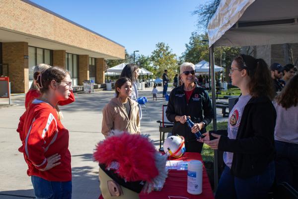 students gathering around outside of Pressey Hall at Audiology tent