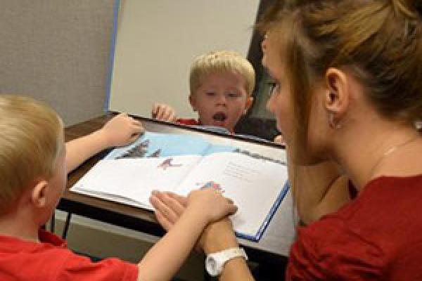 Mary Beth Schmitt working with child