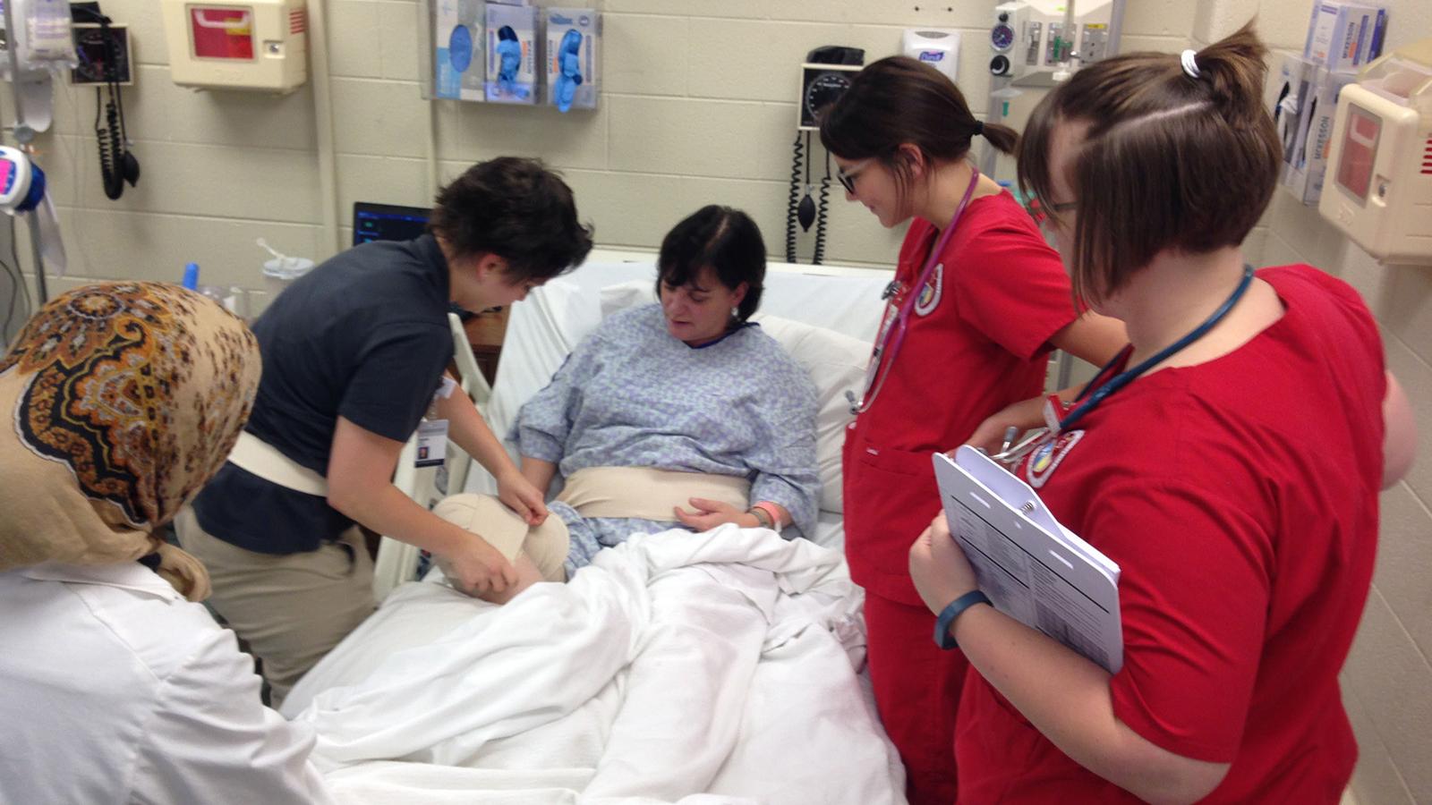 Students working with patient 