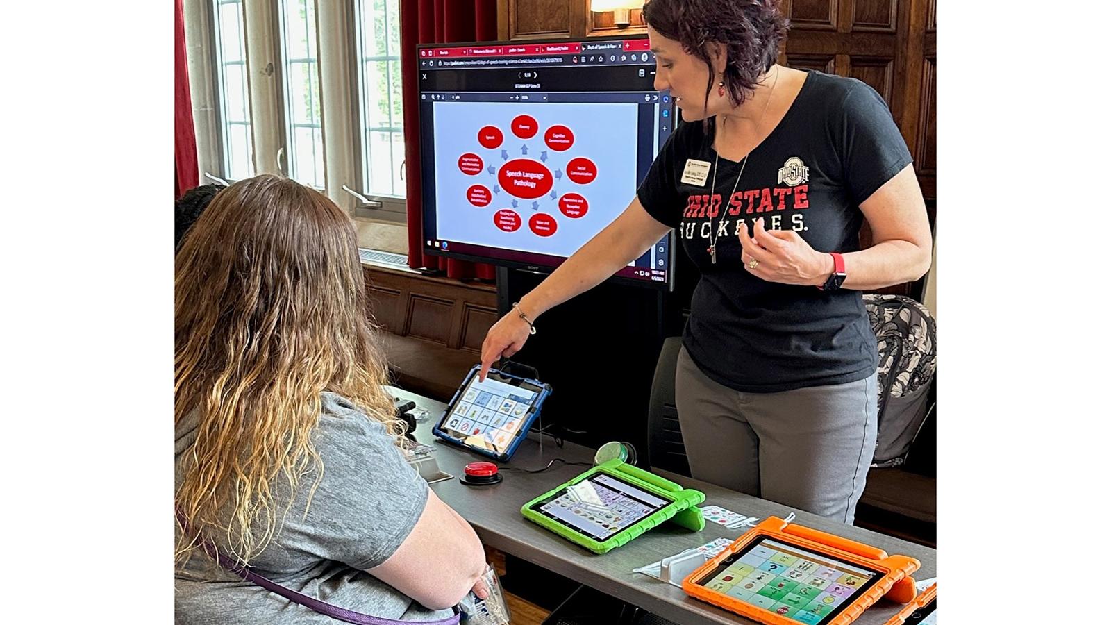 Amy Sonntag demonstrating AAC technology for a participant