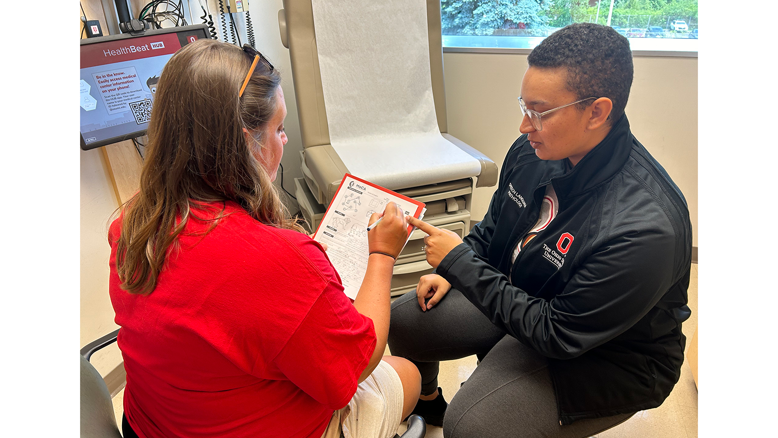 Student conducting cognitive screening with patient