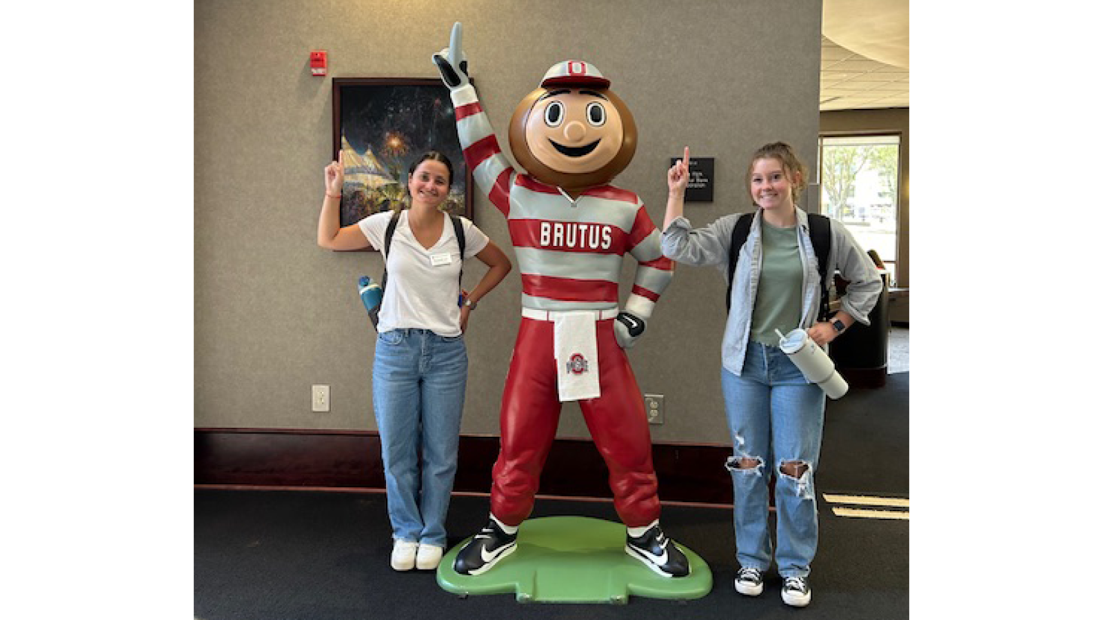 Student ambassador on each side of Brutus statue