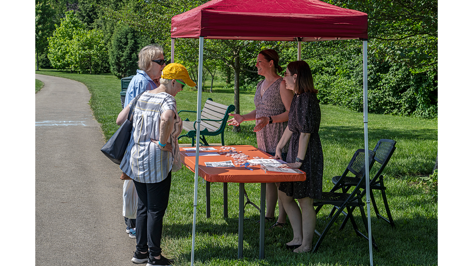 Two participants checking out the Swallow tent with Dr. Kantarcigil and Nicole Wiksten