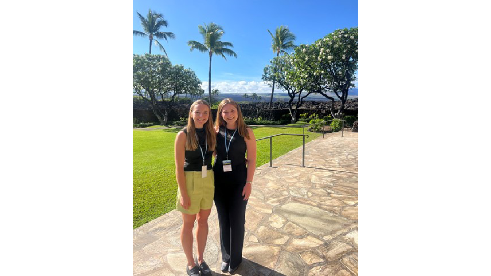 Courtney Jewell and Grace Terry standing in front of palm trees