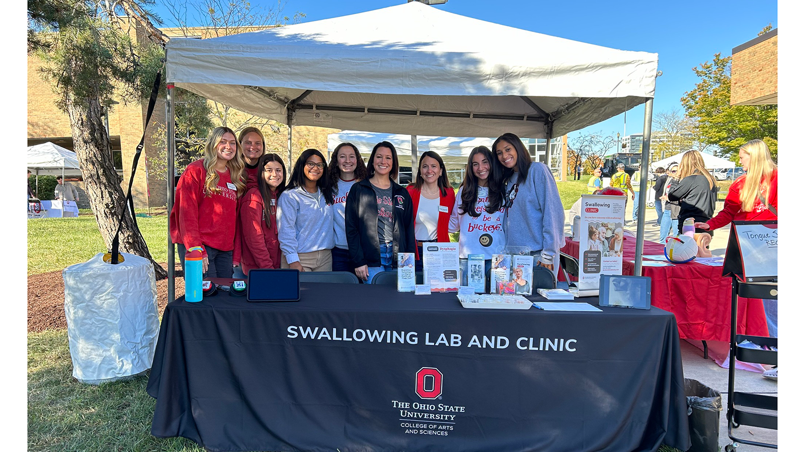 Group photo of students and faculty at Swallowing booth