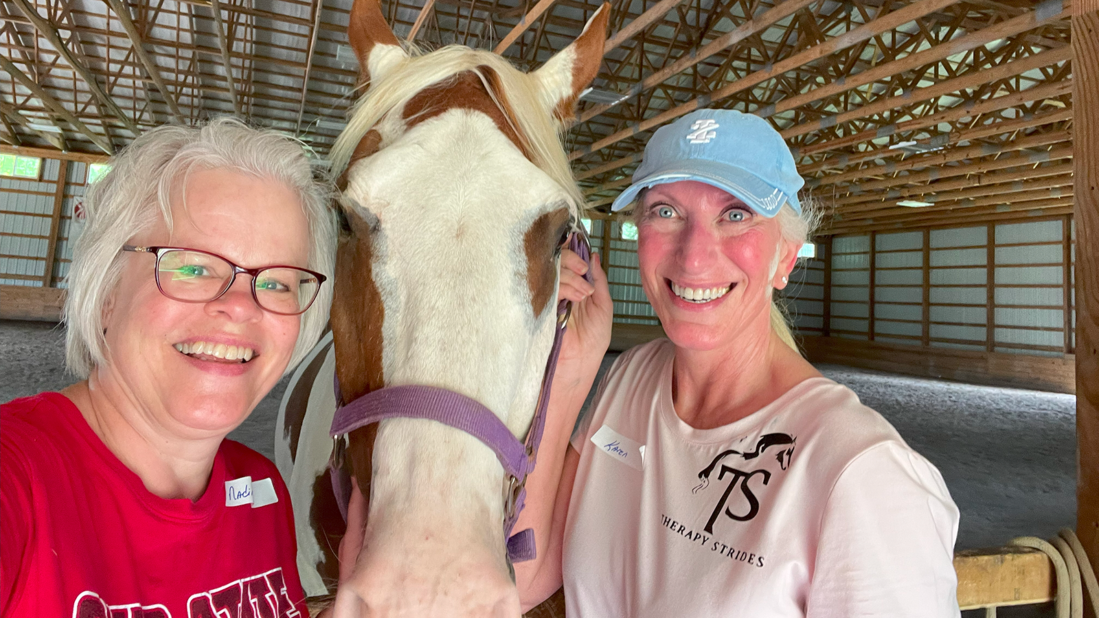 Nadine Whiteman and Karen Carver with a horse in between them